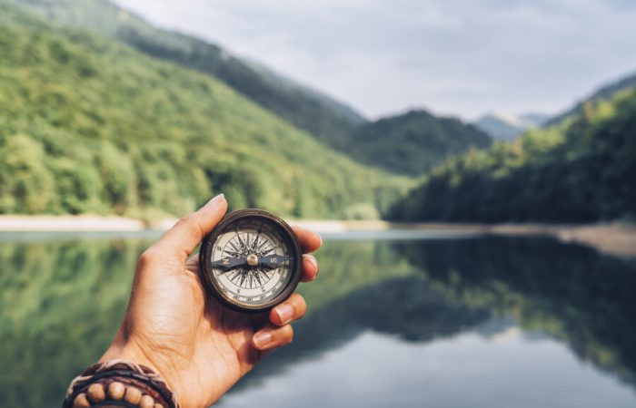 Lost woman on the mountain, orienting herself with a compass. Find a solution.